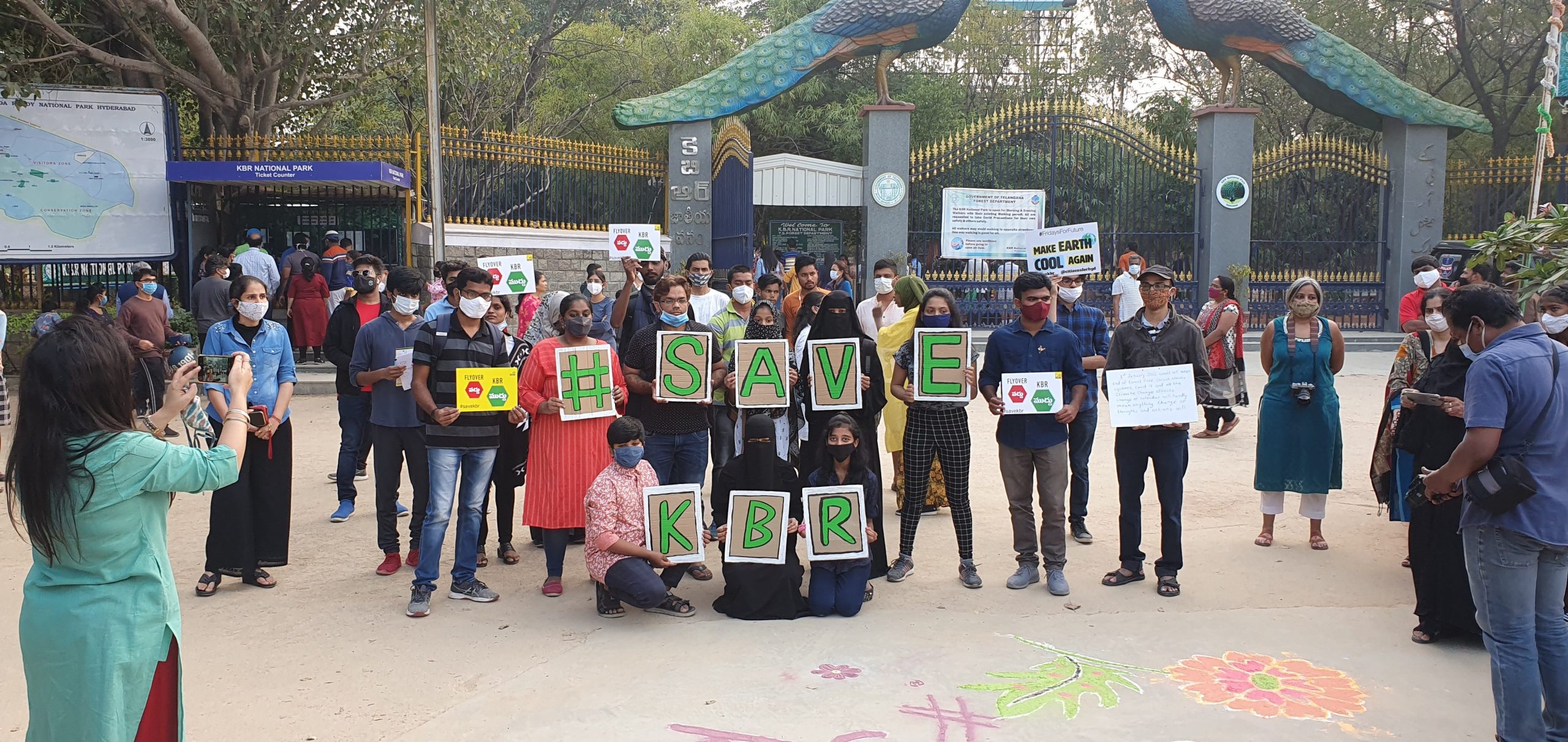 Activists stood with Save KBR spelt in signs. 