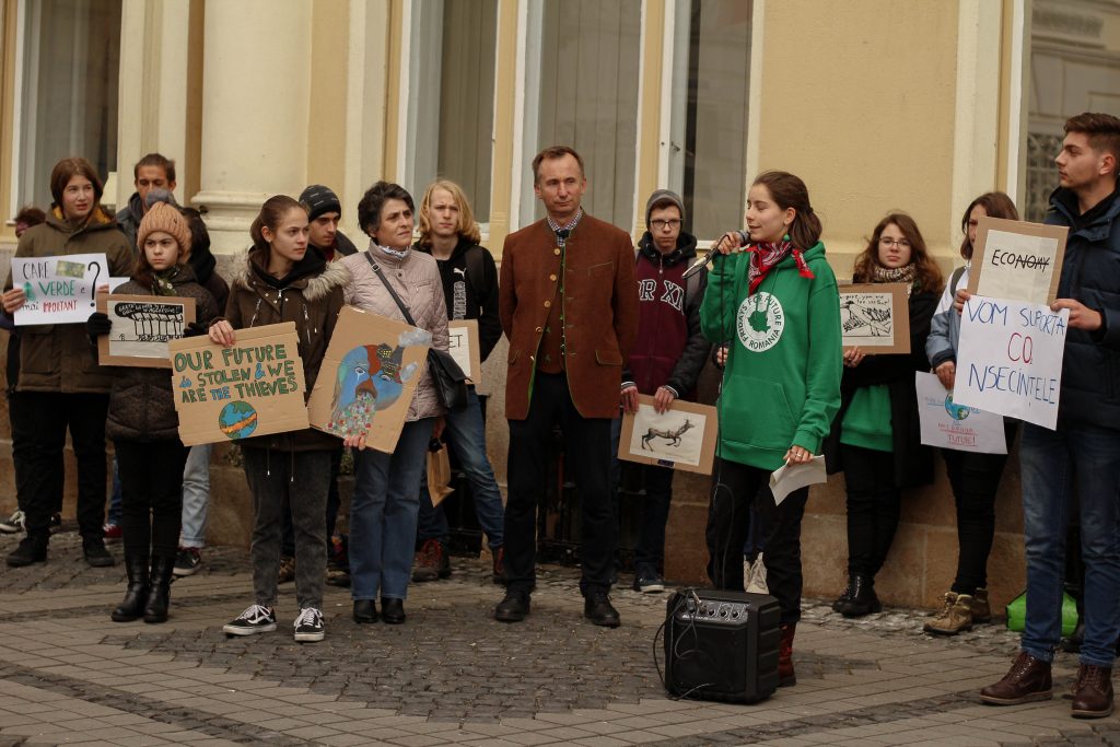 Paula speaking to a crowd of about 15 at a climate strike. 