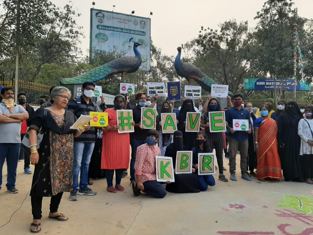 Activists stood with signs reading Save KBR. 