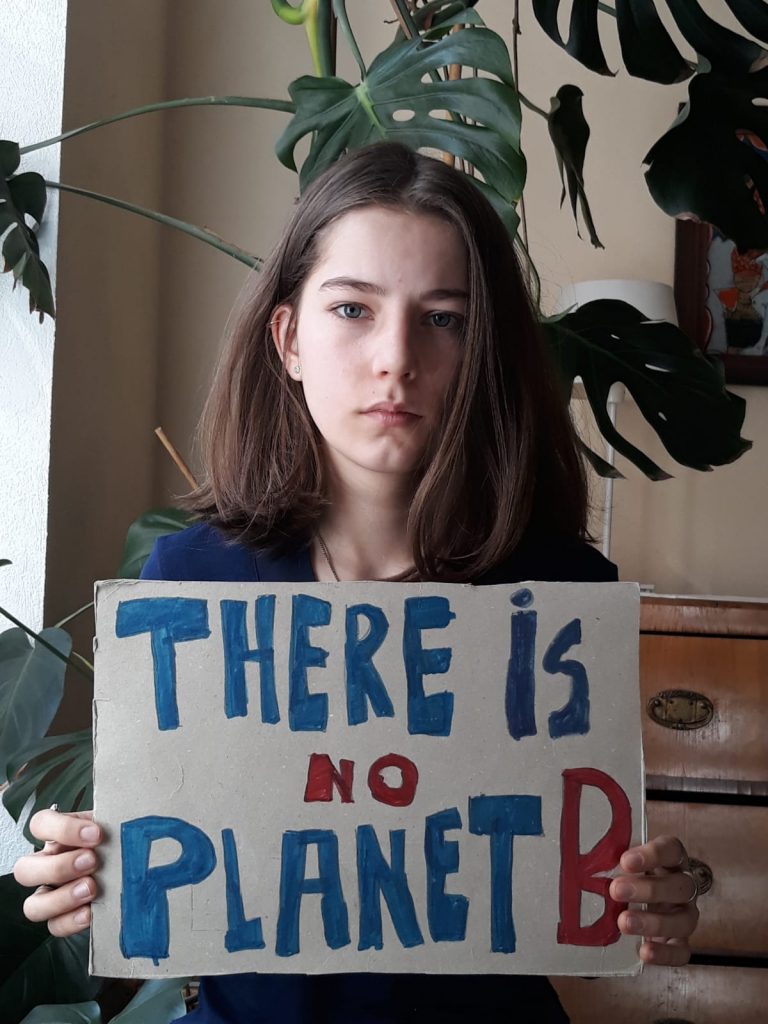 Paula holding a sign reading there is no planet B, as part of the 2020 digital strike. 